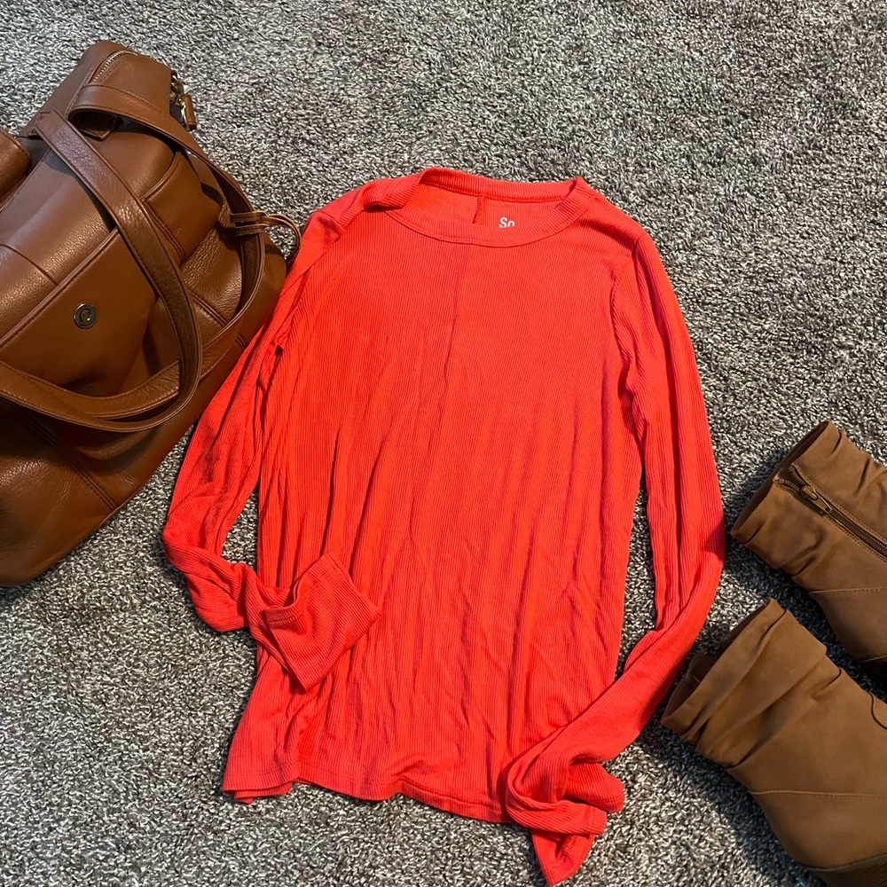 Bright red long sleeve top.
